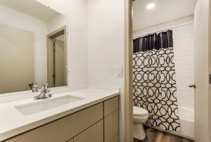 Bathroom with white subway tiled tub shower combination